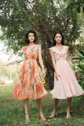 Pleated silk midi dress with ruffle neckline and soft-flowing sleeveless silhouette